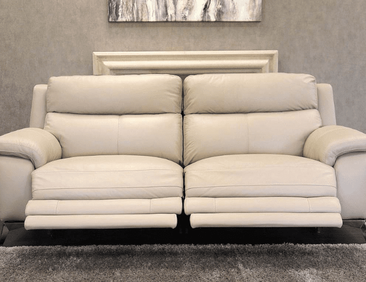 A white modern couch received a deep leather polish to maintain its cleanliness.
