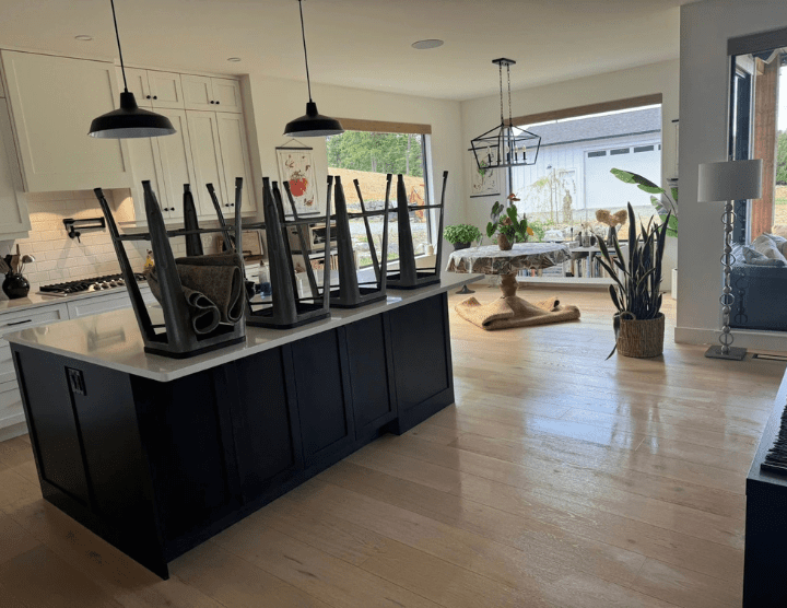 A living room and kitchen in the middle of a deep clean.