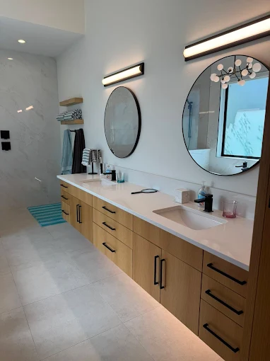 Residential home cleaning company completes a deep clean of their client's modern bathroom. They cleaned the tiles, mirrors, and double sinks.